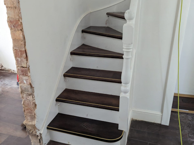 Luxury vinyl tiles fitted onto the tread and nosing of the stairs