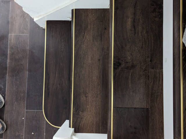 Luxury vinyl tiles fitted onto the tread and nosing of the stairs