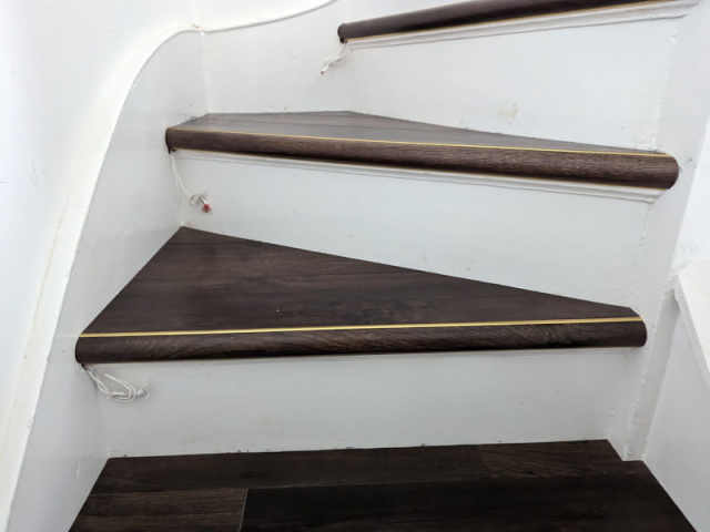 Luxury vinyl tiles fitted onto the tread and nosing of the stairs