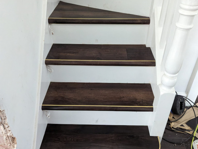 Luxury vinyl tiles fitted onto the tread and nosing of the stairs